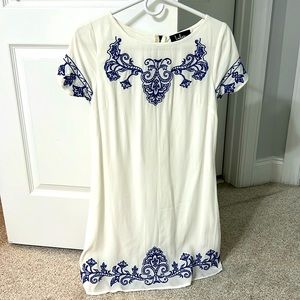 White dress with blue embroidery